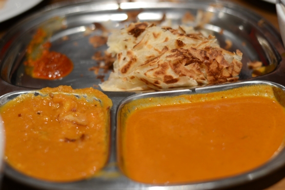 Roti canai with two curry dips and sambal sauce