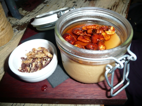 Butterscotch panna cotta with caramelized nuts and coffee liquor served with almond chocolate candy